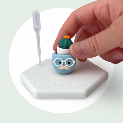A hand sets the Cactus Pal into the Chilly Chap pot on its magnetic coaster
