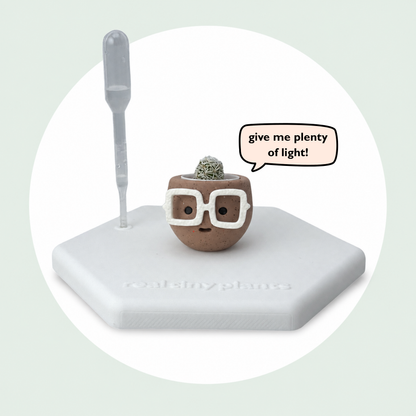 Hot Cocoa on its magnetic coaster with a speech bubble that says give me plenty of light