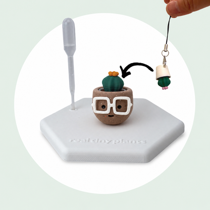 Cactus Pal keychain shown dropping into the Hot Cocoa pot as a forever plant backup