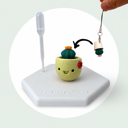 Cactus Pal keychain shown dropping into the Maple Cookie pot as a forever plant backup