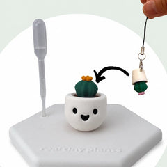 Cactus Pal keychain going into the pot